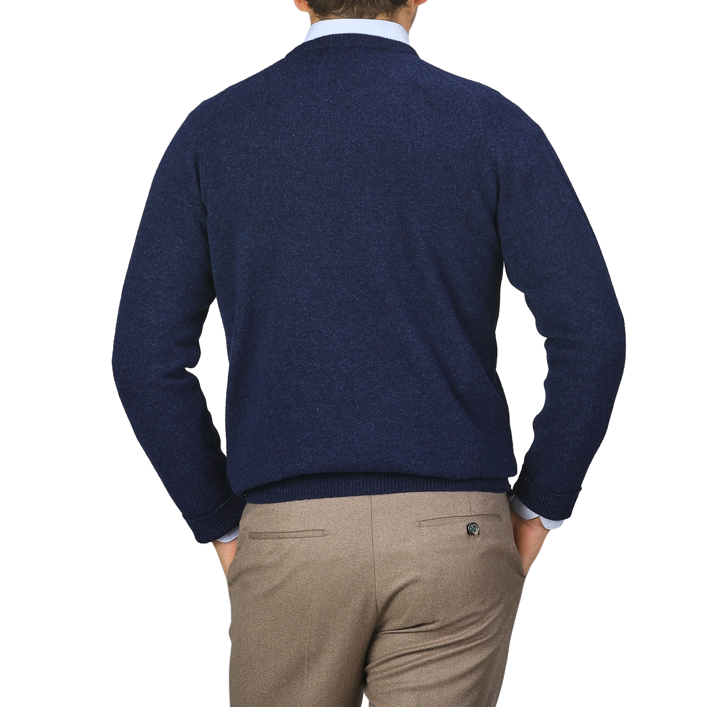 An individual is wearing an Alan Paine Indigo Blue Lambswool V-Neck sweater and beige pants, standing with his back to the camera, hands in pockets, against a plain gray background.