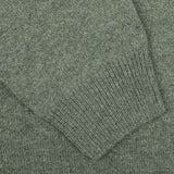 Close-up image of the sleeve of the Alan Paine Landscape Green Lambswool Crew Neck, showcasing its detailed stitching and ribbed cuff, crafted from soft Australian lambswool for a contemporary fit.