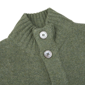 A close up of a green Alan Paine Landscape Green Lambswool Landford Cardigan with buttons made of lambswool.