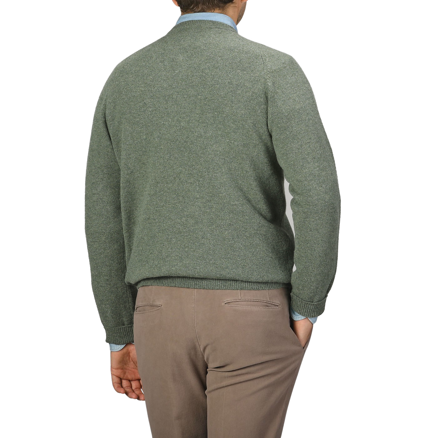 A person wearing an Alan Paine Landscape Green Lambswool V-Neck sweater and beige pants is shown from behind against a plain background.