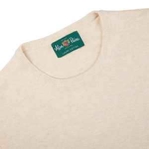 A Light Beige Alan Paine luxury cotton crewneck sweater with a green label on it.