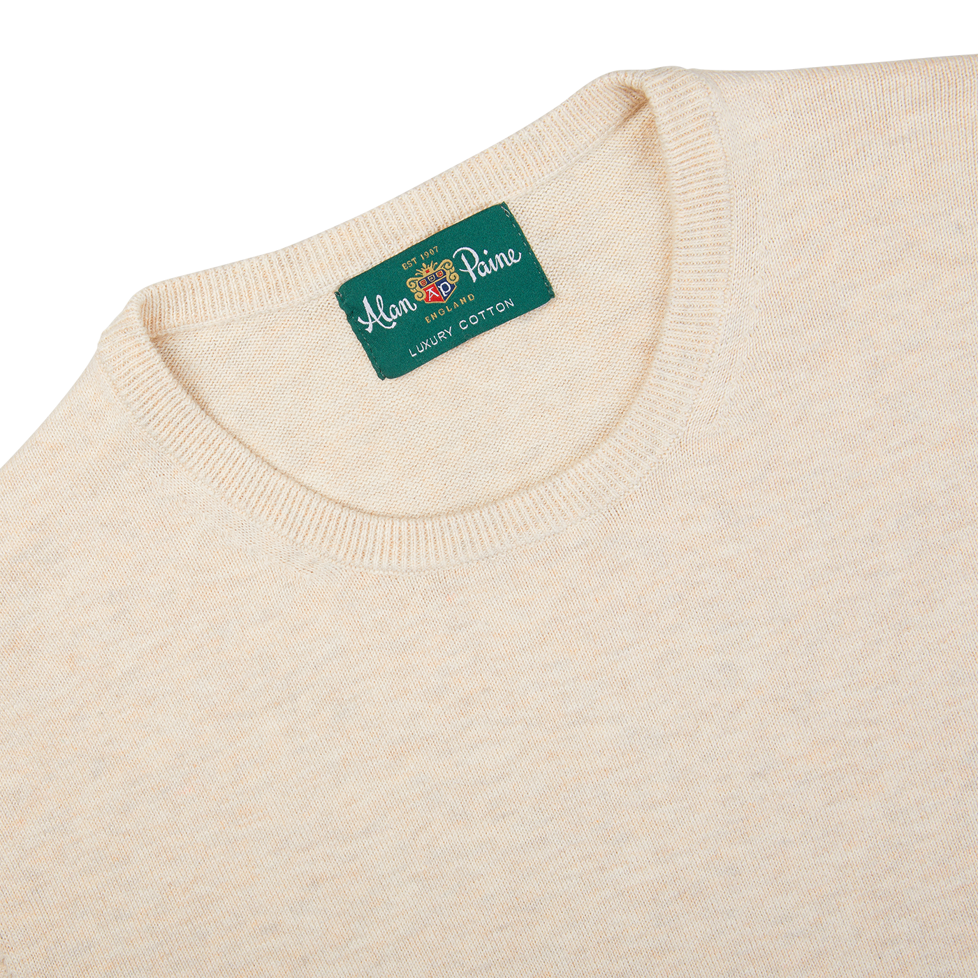 A Light Beige Alan Paine luxury cotton crewneck sweater with a green label on it.