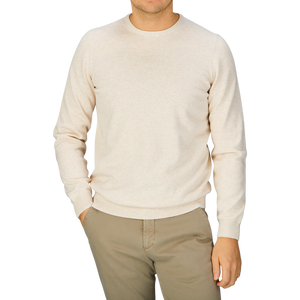 A man wearing an Alan Paine Light Beige Luxury Cotton Crewneck sweater and khaki pants.
