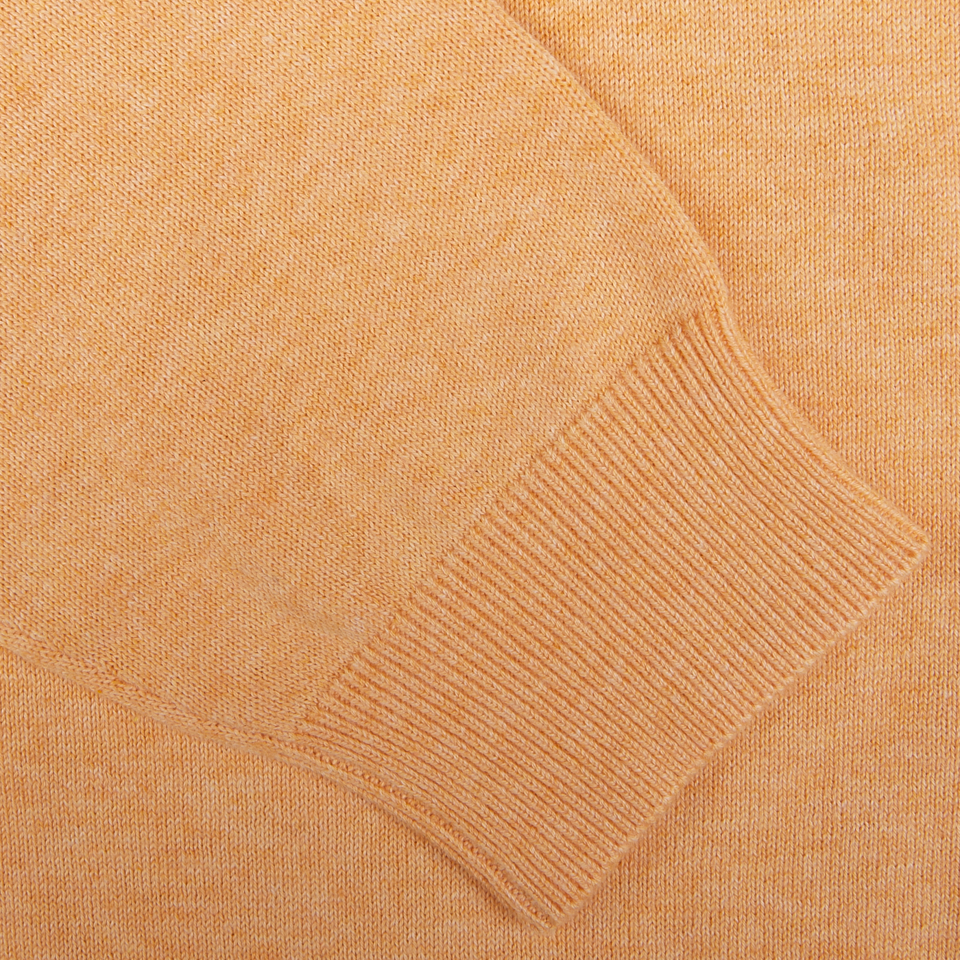 Close-up of an Alan Paine luxury cotton cashmere beige sweater showcasing the knitted pattern and ribbed cuff.