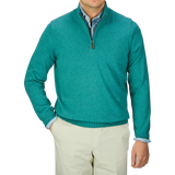A man wearing a Moorland Green Luxury Cotton 1/4 Zip Sweater by Alan Paine and tan pants.