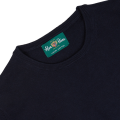 Navy blue Alan Paine luxury cotton crewneck with brand label visible on the collar.