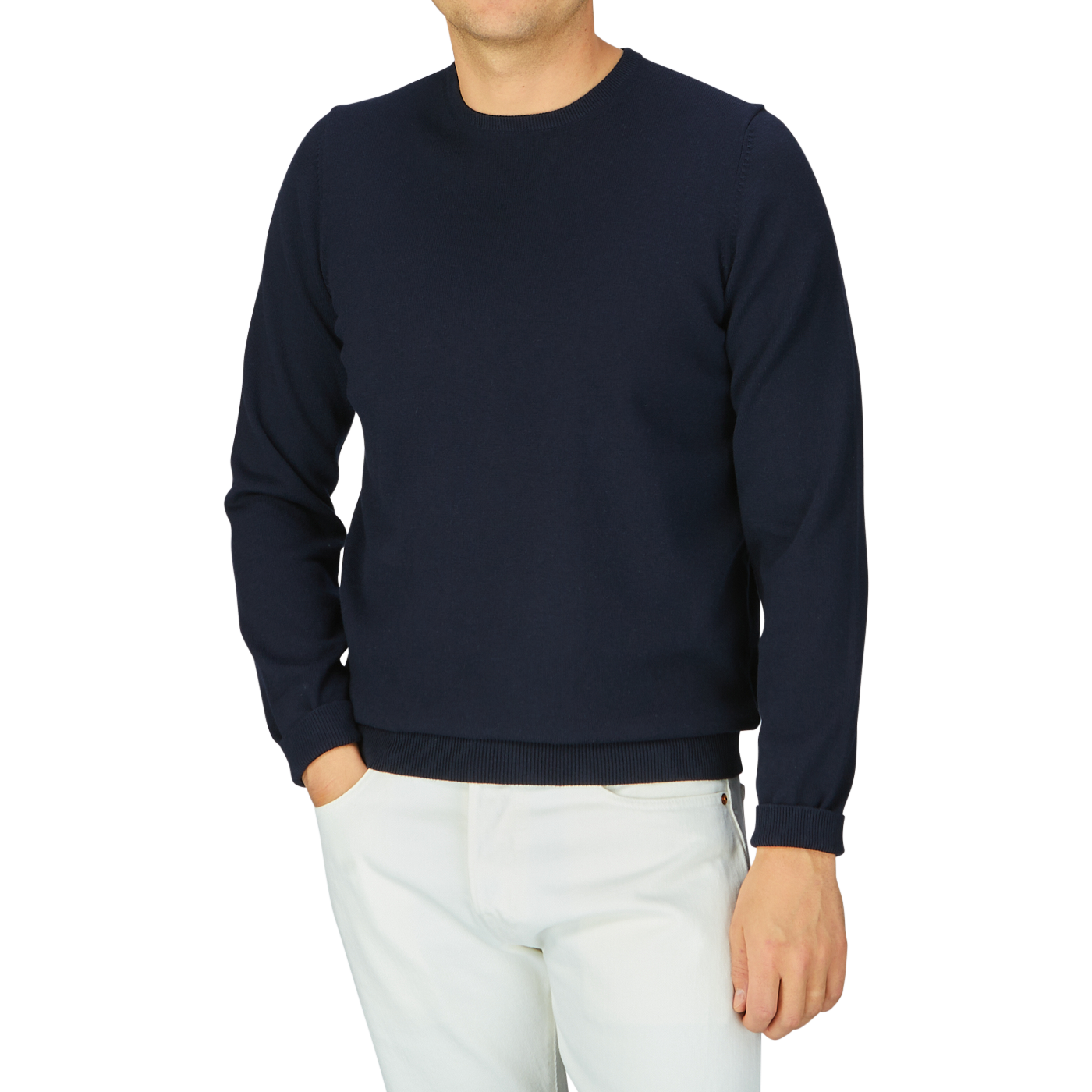 Man wearing an Alan Paine Navy Blue Luxury Cotton Crewneck sweater and white pants against a gray background.