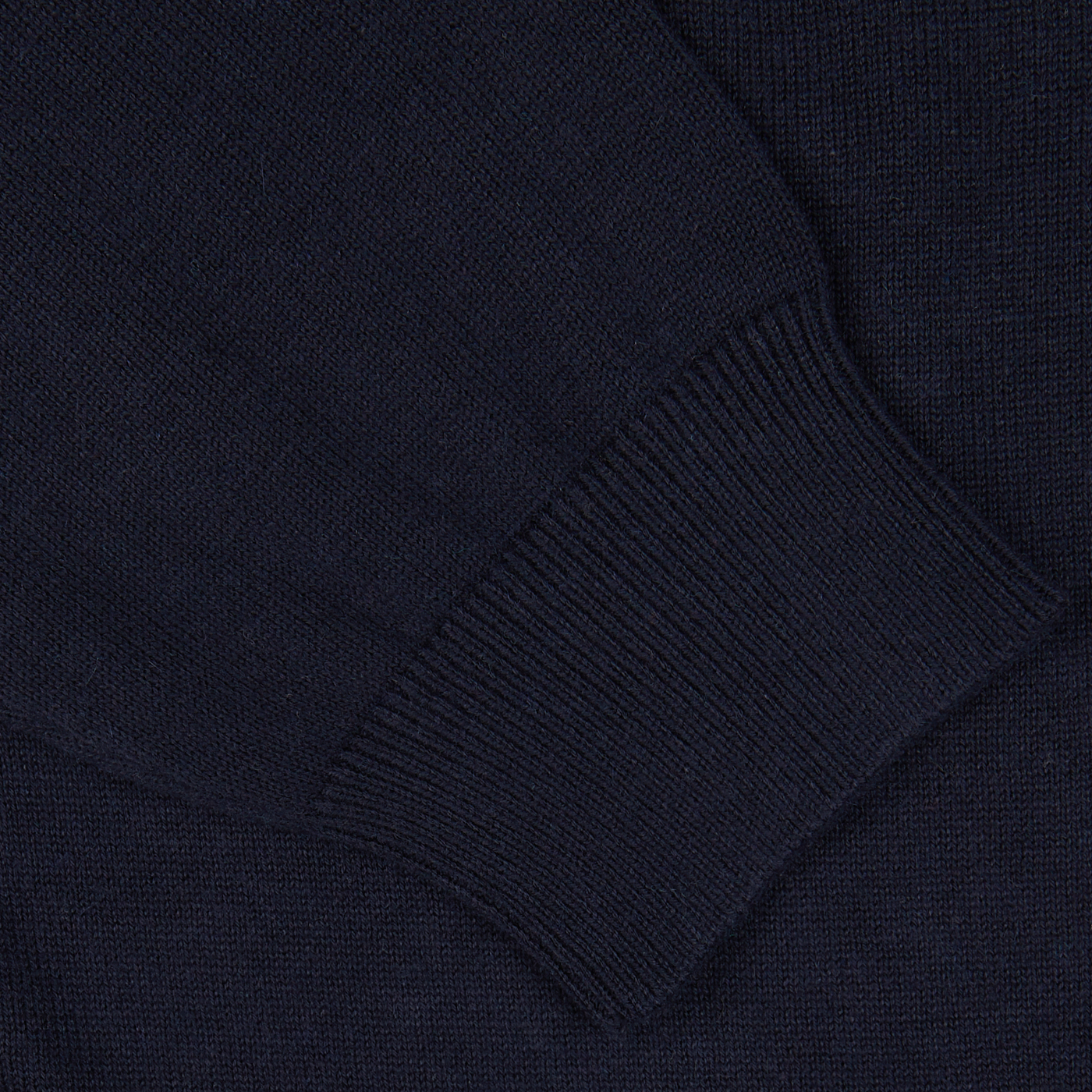 Close-up of an Alan Paine Navy Blue Luxury Cotton V-Neck Sweater with ribbed detailing.