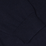 Close-up of an Alan Paine Navy Blue Luxury Cotton V-Neck Sweater with ribbed detailing.