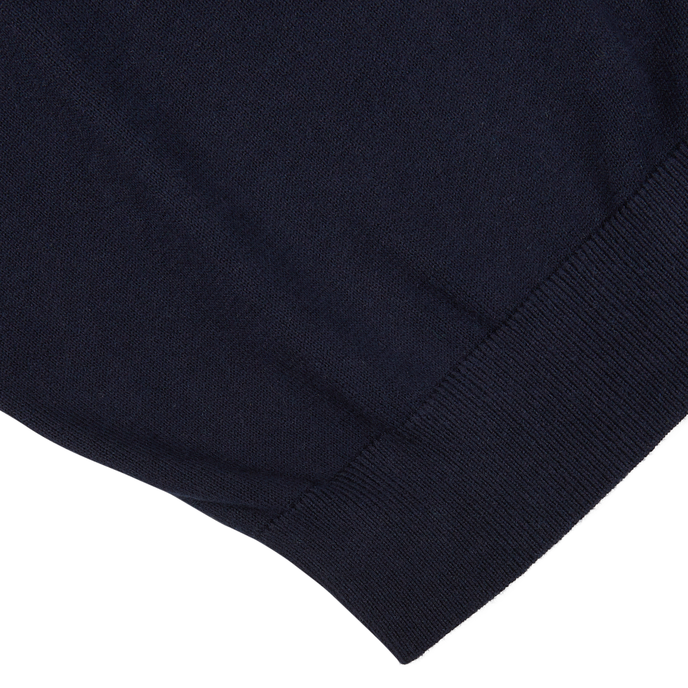 Close-up of the hem and fabric texture of a dark blue, Alan Paine luxury cotton cashmere summer v-neck sweater.