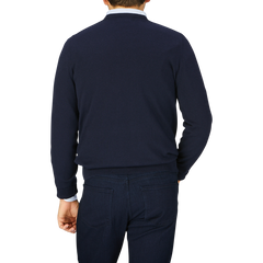 Man seen from behind, wearing a dark blue Alan Paine Navy Blue Luxury Cotton V-Neck Sweater and pants.