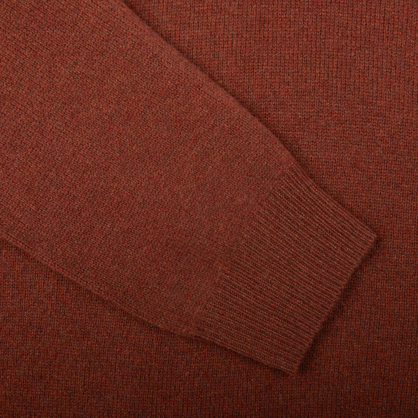 Close-up of a Nebula Red Brown Lambswool V-Neck sleeve by Alan Paine, showcasing the texture and ribbed cuff.