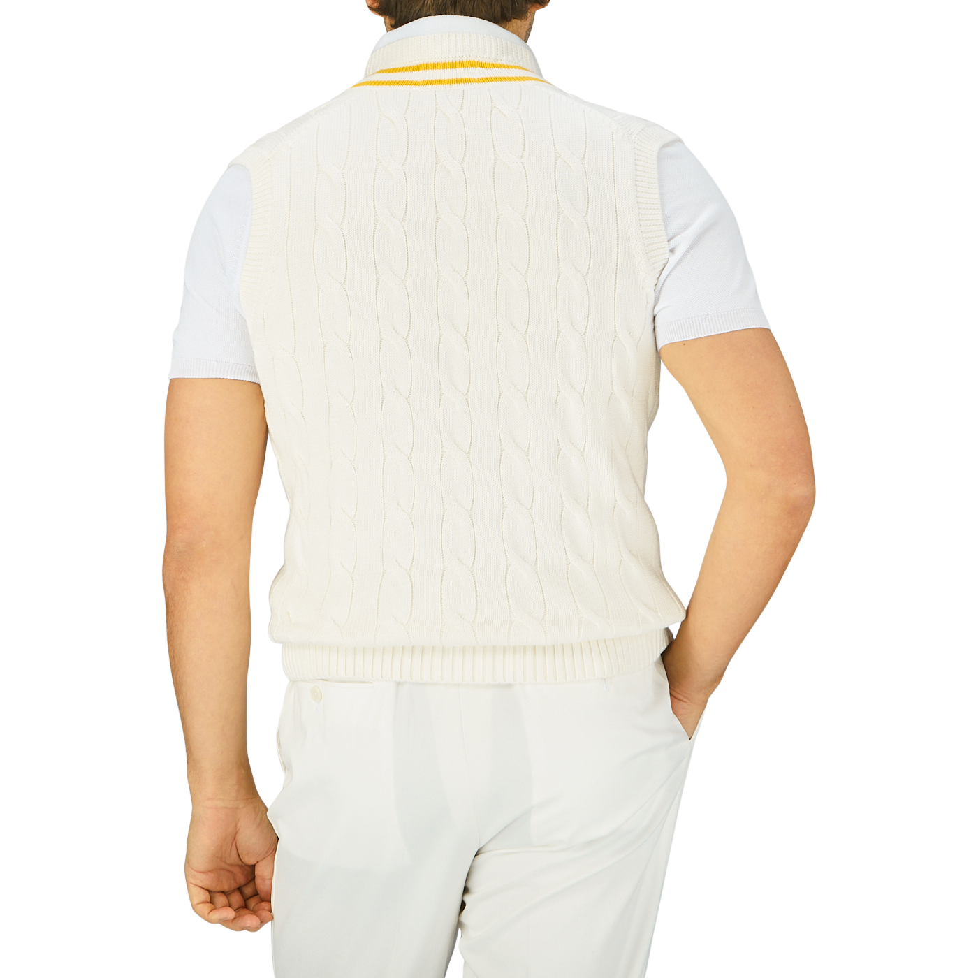 A person seen from behind wearing an Off-White Yellow Striped Cotton Cricket Slipover by Alan Paine and white trousers.