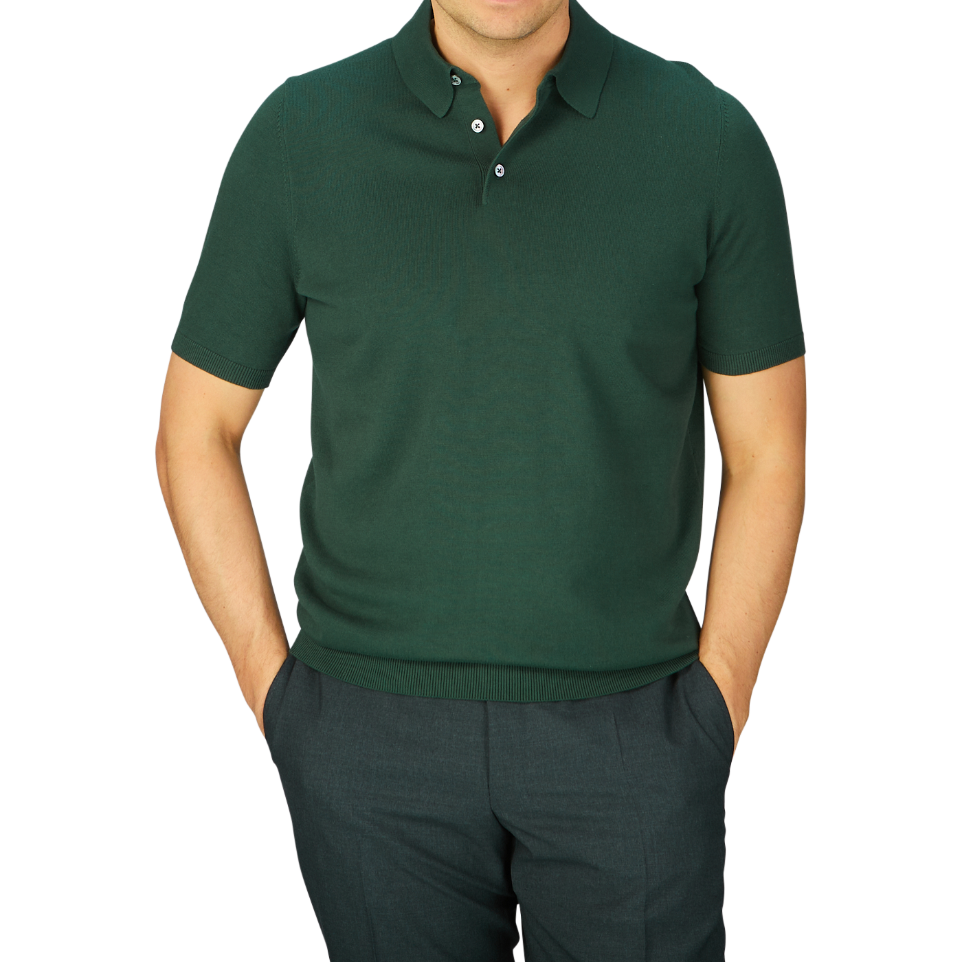 Man in a Alan Paine Racing Green Knitted Cotton Polo Shirt and dark trousers against a blue background.