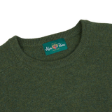 An Alan Paine crew neck sweater in rosemary green, made of lambswool.