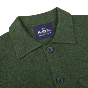 An Alan Paine Rosemary Green Lambswool Two Pocket Overshirt with a label on the front.