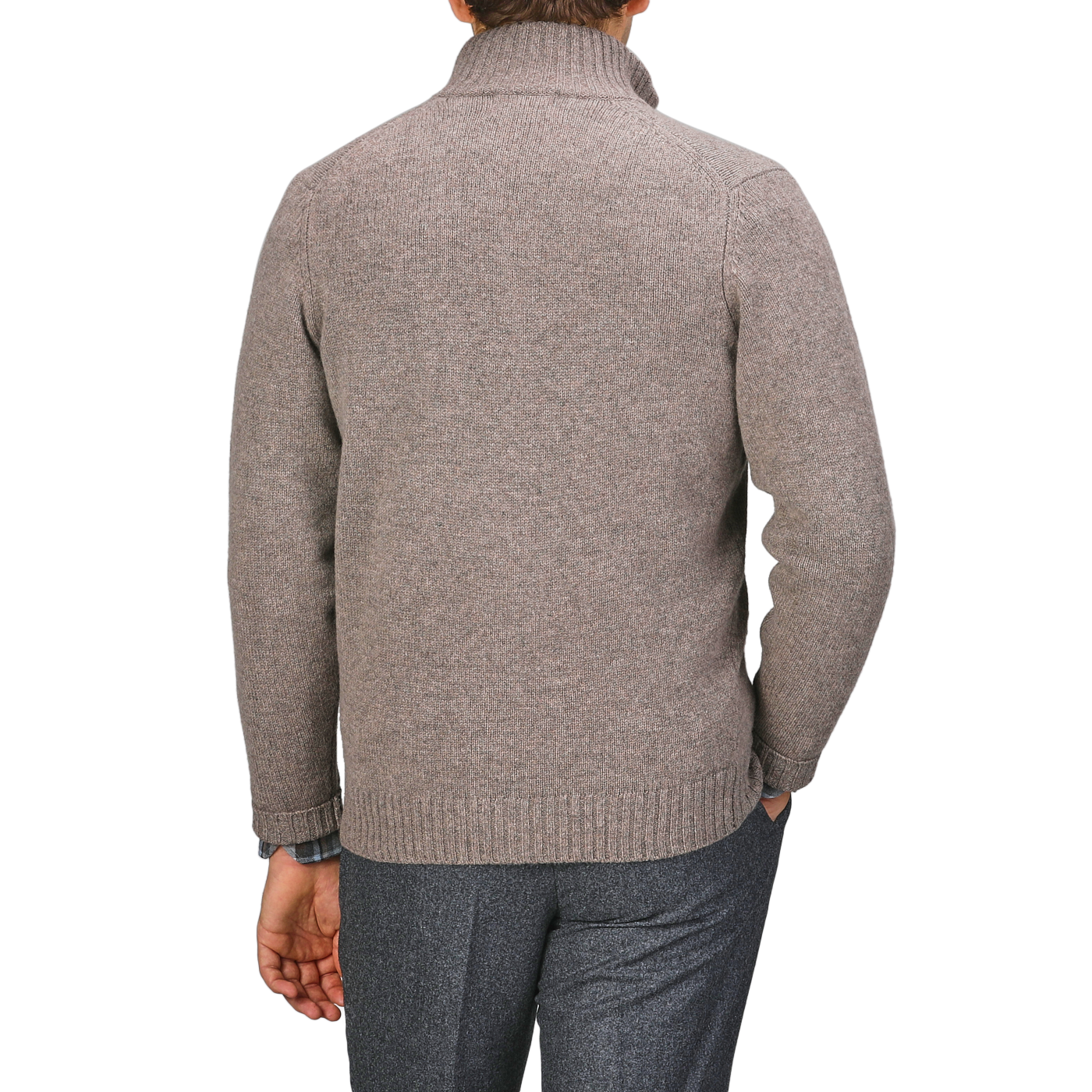 A person in a Taupe Beige Lambswool Landford Cardigan by Alan Paine and gray pants stands with their back against a gray backdrop.