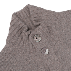 A close-up of the taupe beige Alan Paine Landford lambswool cardigan showcases a ribbed collar and two large buttons.