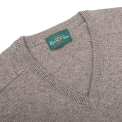 The Vole Beige Lambswool V-Neck, crafted from Australian lambswool, features an updated fit and a green label that reads "Alan Paine" and "EST 1907.