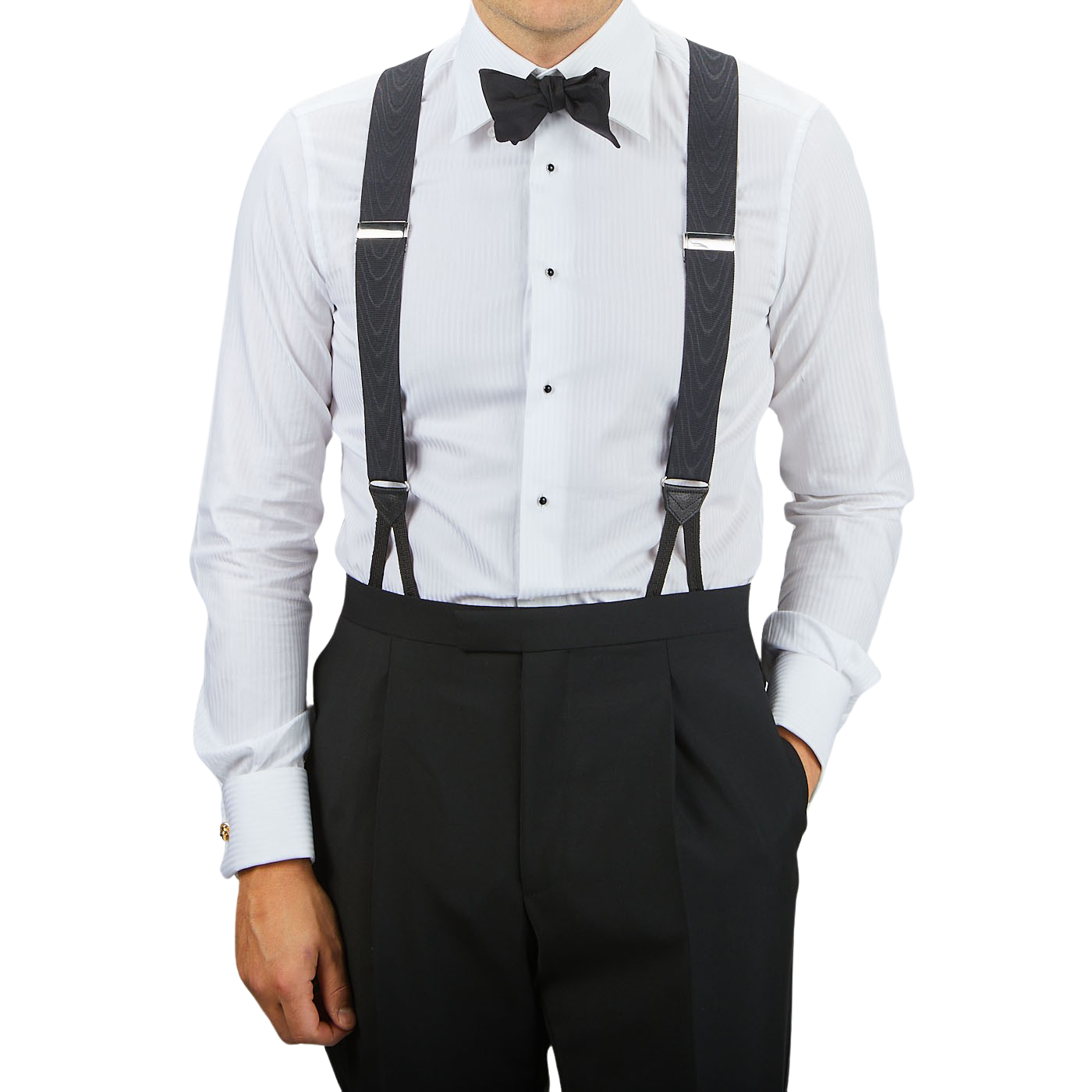 A person stands wearing a white dress shirt, black bow tie, and Black James Bond Moiré 38 mm Braces by Albert Thurston, with hands in black dress pants pockets against a plain background.