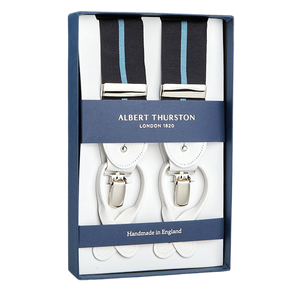 A boxed set of Albert Thurston suspenders, featuring white leather and blue Eton stripe elastic straps, labeled "Handmade in England" and inspired by Gordon Gekko from Wall Street.