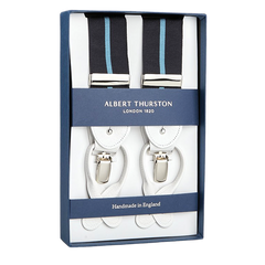 A boxed set of Albert Thurston suspenders, featuring white leather and blue Eton stripe elastic straps, labeled "Handmade in England" and inspired by Gordon Gekko from Wall Street.