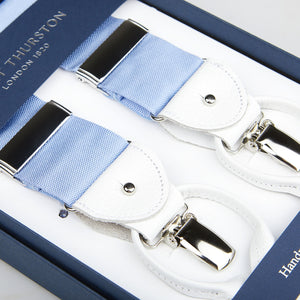 Albert Thurston blue nylon and white leather 40 mm braces with silver clips and leather details, displayed in a box labeled "Albert Thurston London 1820.