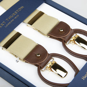 A pair of Albert Thurston Dark Beige Nylon Elastic 35mm Braces displayed in a blue box with gold lettering, featuring beige straps and brown leather details.