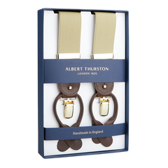 A pair of handmade Albert Thurston Dark Beige Nylon Elastic 35mm braces in a presentation box, highlighting their English craftsmanship.