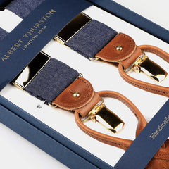 The Albert Thurston Denim Blue Cotton Cognac Leather 38mm Braces feature a boxed set of suspenders with gold-toned clips and hardware, crafted in refined denim blue cotton and tan leather detailing.