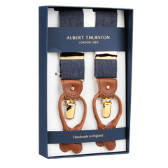 Albert Thurston's Denim Blue Cotton Cognac Leather 38mm Braces feature a handmade English design with denim-blue cotton, brown leather accents, and gold-toned clips.