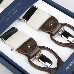 A pair of Light Beige Linen Leather 35 mm Braces with brown leather accents, crafted from Irish linen fabric, presented in a blue gift box labeled "handmade by Albert Thurston.