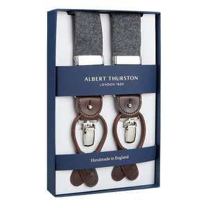 A pair of handmade Albert Thurston Light Grey Wool Flannel 35 mm Braces displayed in an open box.
