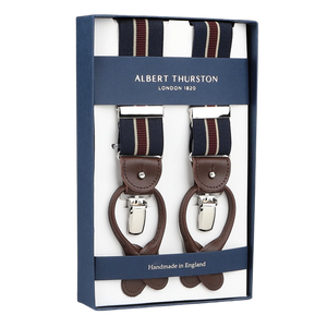 Albert Thurston's boxed handmade braces, labeled as Navy Burgundy Striped Nylon Elastic 35mm Braces, showcase a navy blue-burgundy pattern with brown leather and silver clips, proudly crafted in England.