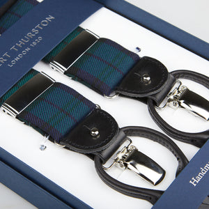 A pair of Navy Green Wool Black Watch 35 mm Braces with leather details, displayed in a box labeled "Albert Thurston.