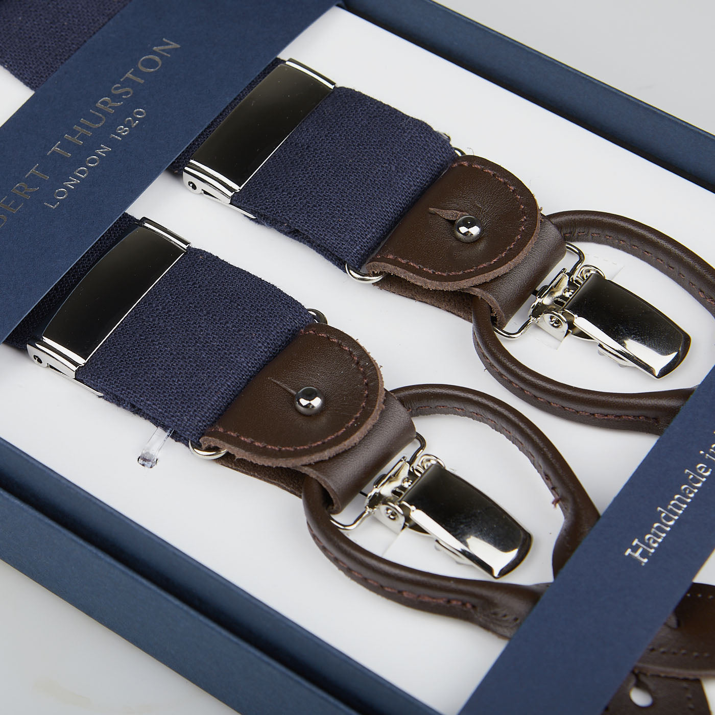 A set of Navy Linen and Brown Leather 35 mm Albert Thurston Braces, displayed in an elegant box.