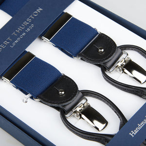 Blue and black handmade suspenders with silver clips, displayed in an open box labeled "Albert Thurston" were replaced with Navy Nylon Black Leather 35 mm Braces by Albert Thurston.