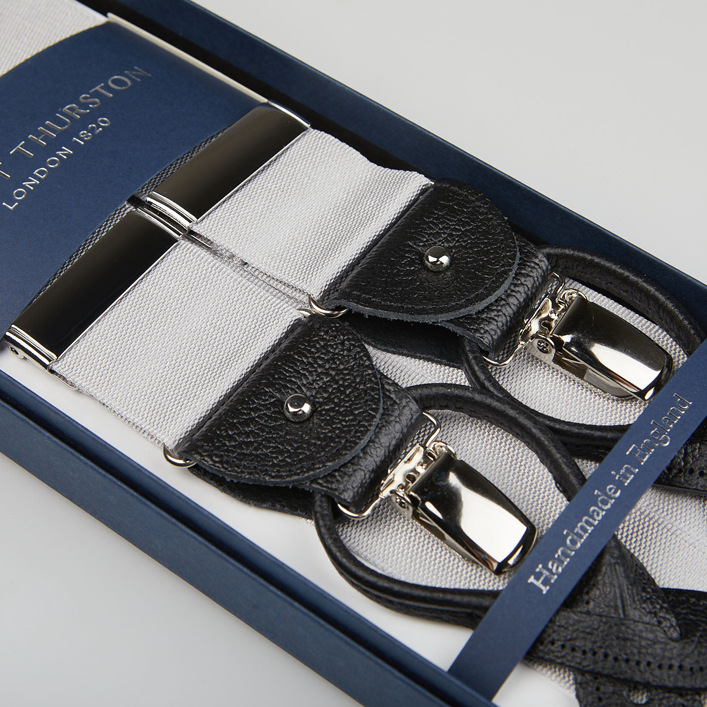 Luxury Silver Nylon Black Leather 40 mm braces with metal clasps, displayed in a navy blue presentation box labeled "Albert Thurston.