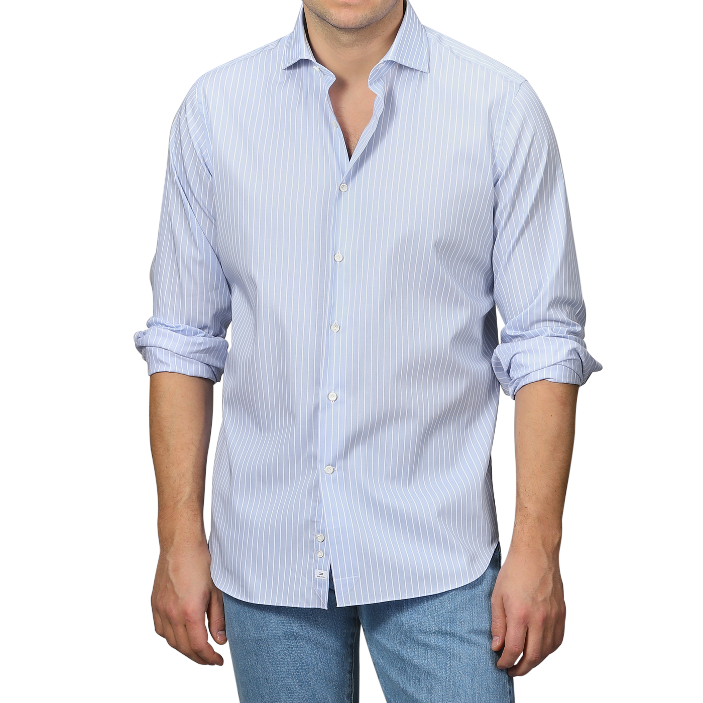 A man in an Alessandro Gherardi Blue Wide Striped Cotton Single Cuff Shirt with rolled-up sleeves is paired with jeans and stands against a gray background.