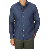 A person is wearing an Alessandro Gherardi Dark Blue Cotton Denim Single Cuff Shirt with brown trousers. The image is cropped at the neck and thighs.