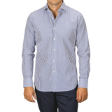 A person wearing an Alessandro Gherardi Dark Blue Striped Cotton Single Cuff Shirt and dark trousers stands against a plain background.