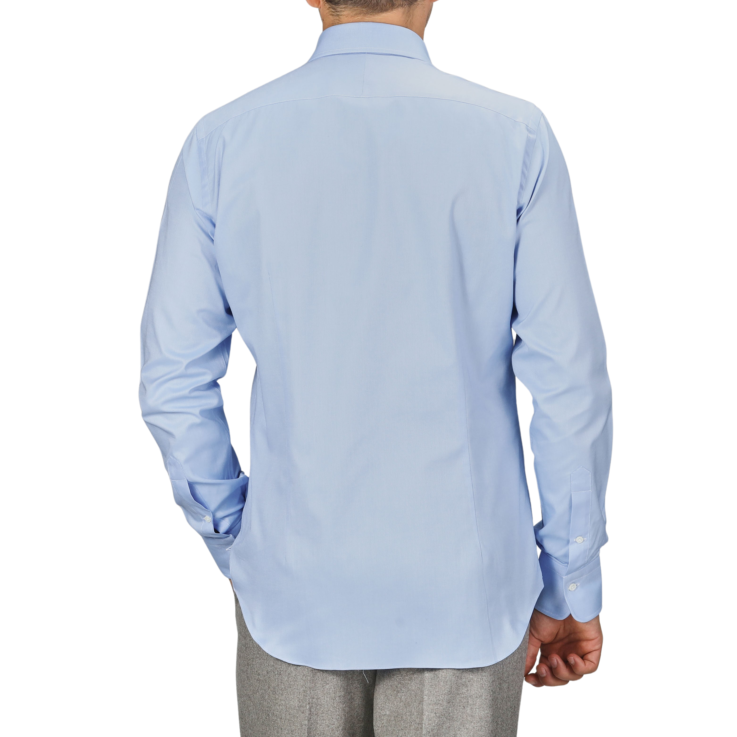 A person wearing an Alessandro Gherardi Light Blue Cotton Oxford Single Cuff Shirt and gray pants, facing away from the camera with one hand in their pocket.