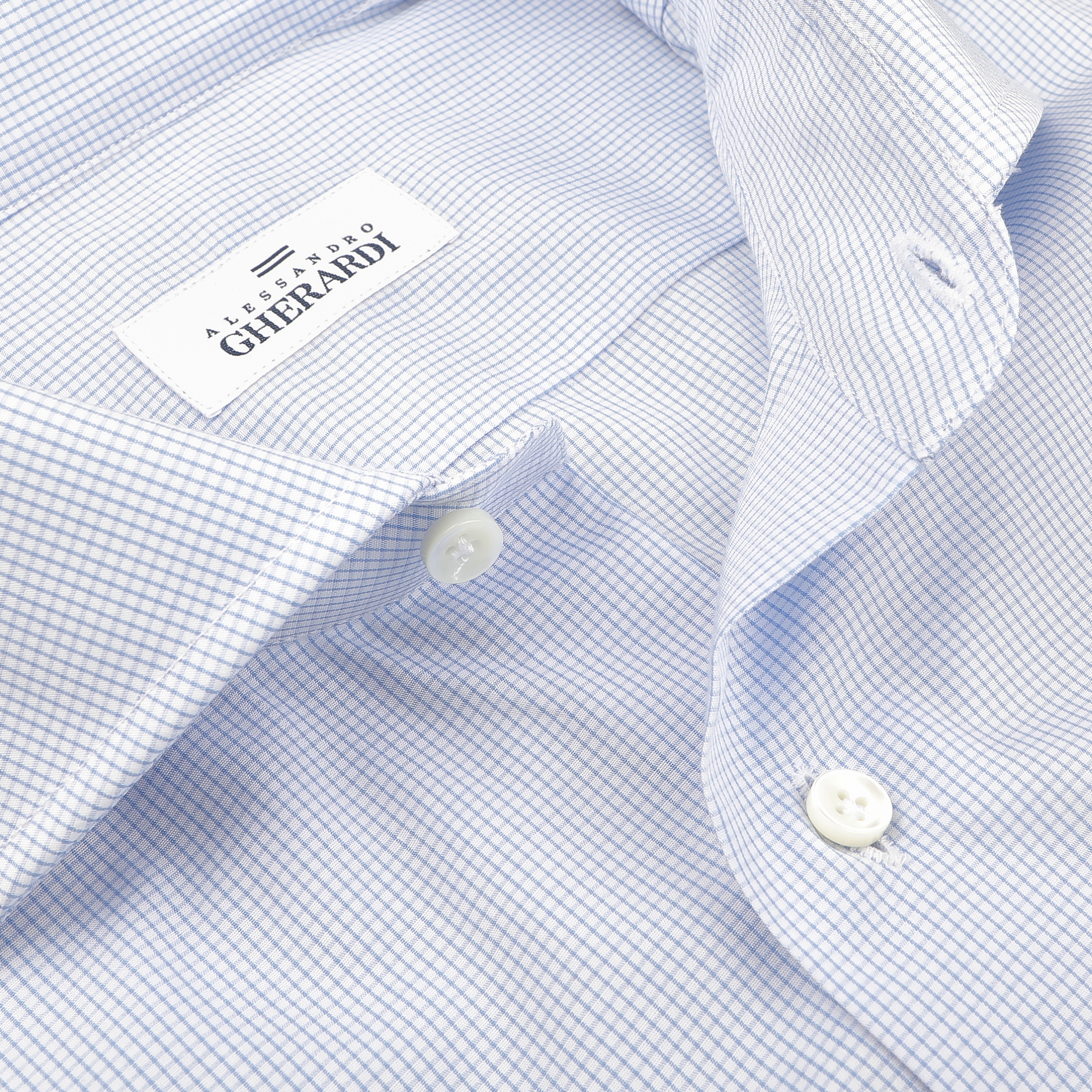 Featuring a close-up of the Light Blue Grid-Checked Cotton Single Cuff Shirt by Alessandro Gherardi, this piece captures the essence of men's formal wear with its partially buttoned design for a relaxed yet refined look.