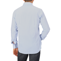 A person wearing an Alessandro Gherardi Light Blue Striped Cotton Single Cuff Shirt and dark jeans, shown from the back against a plain background.