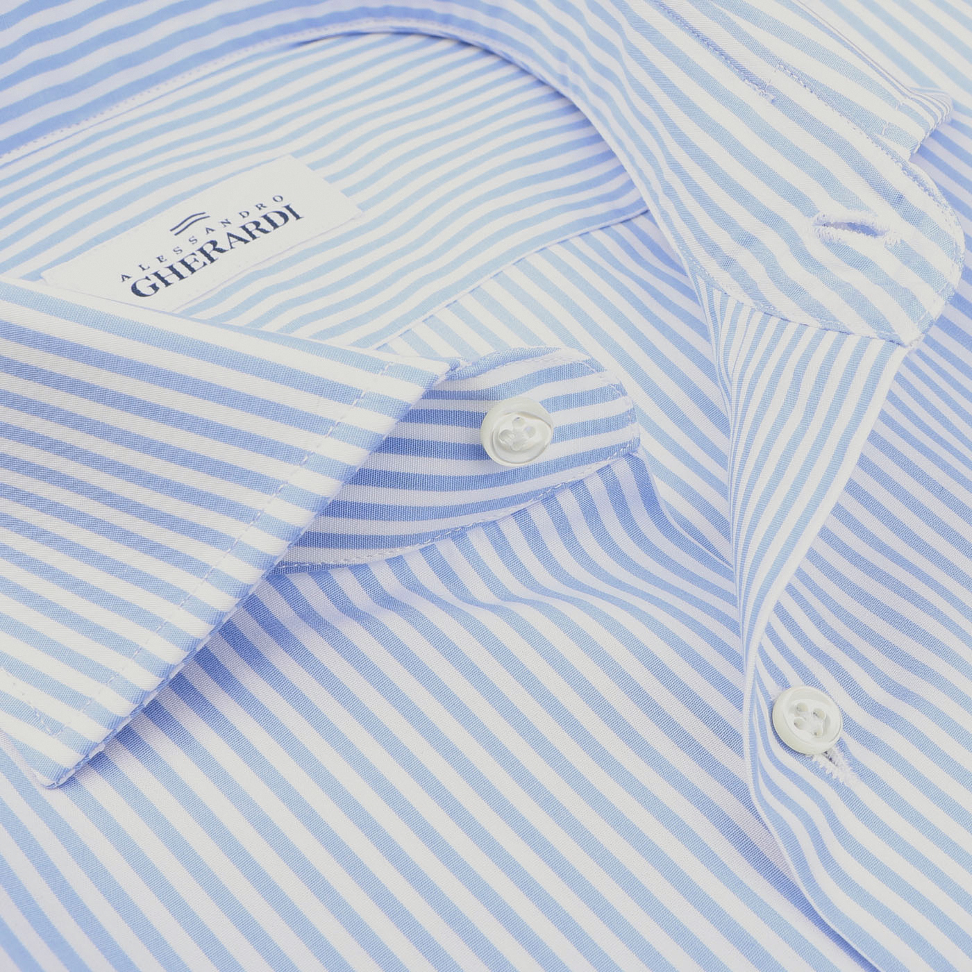 Close-up of the Light Blue Striped Cotton Single Cuff Shirt, featuring visible buttons and a label reading "Alessandro Gherardi." This elegant formal shirt is a prime example of high-quality men's shirts.