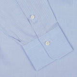 Close-up of an Alessandro Gherardi Sky Blue Cotton Twill Single Cuff Shirt sleeve, showcasing two white buttons on the pure cotton cuff.