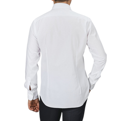 A person wearing an Alessandro Gherardi White Cotton Twill Single Cuff Shirt and black pants, viewed from the back against a plain gray background.