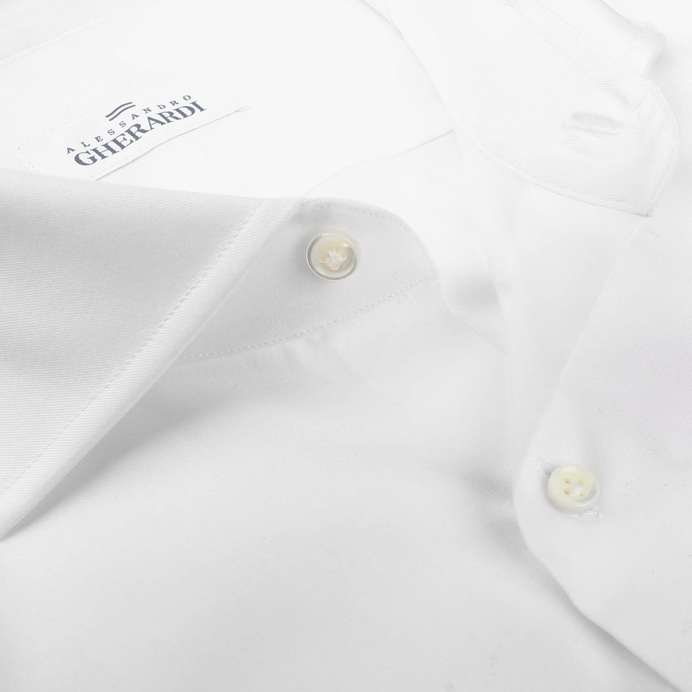 Close-up of a high-quality men's shirt with a buttoned collar. This pure cotton, White Cotton Twill Single Cuff Shirt features a label reading "Alessandro Gherardi.