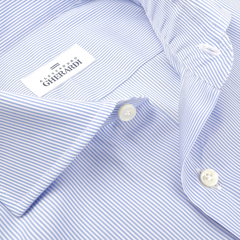 Close-up of a formal blue thin striped cotton shirt by Alessandro Gherardi, featuring white buttons and single cuffs, epitomizing quality men's shirts.