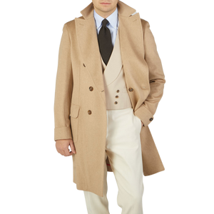 A man in an Alexander Kraft Monte Carlo Camel Beige Pure Cashmere Florence DB Overcoat is posing for a photo.